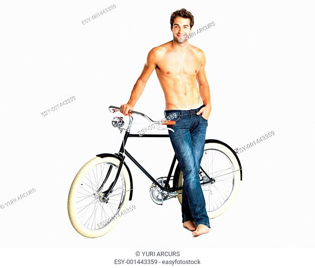 Macho shirtless man standing next to his retro bike