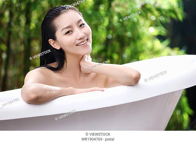 A young woman in the outdoor bathing