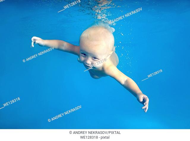 Baby diving in a pool