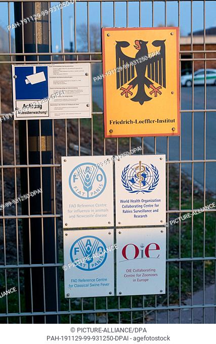 13 November 2019, Mecklenburg-Western Pomerania, Insel Riems: A sign with a federal eagle hangs in the entrance area of the Friedrich-Loeffler-Institute (FLI)...