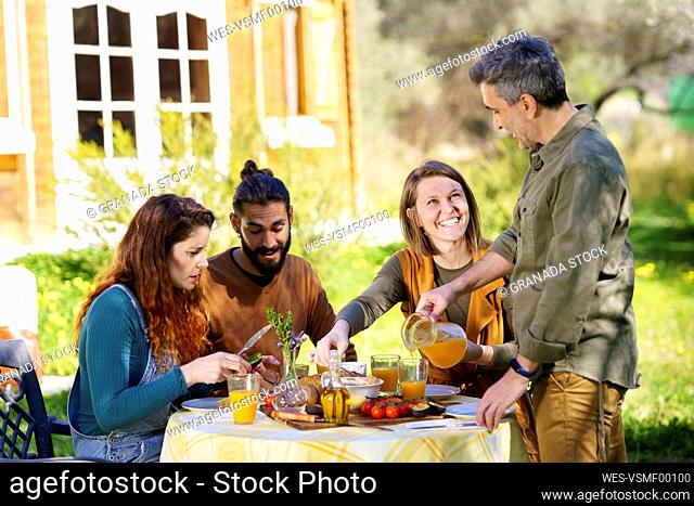 Friends enjoying a healthy vegan breakfast in the countryside
