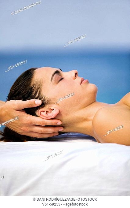 Woman having a massage by the sea