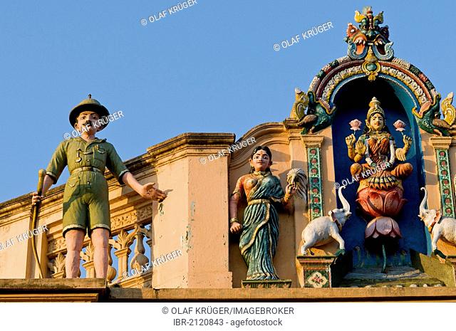 Indian Goddess Lakshmi flanked by elephants and British soldier in Uniform with a rifle, sculptural decoration on an old house, Karaikudi, Chettinad, Tamil Nadu