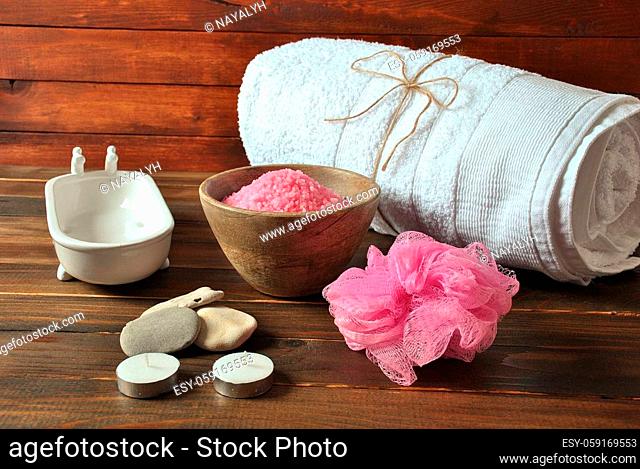 Spa and body care products. Aromatic rose bath Dead Sea Salt on the dark wooden background. Natural ingredients for homemade body salt scrub
