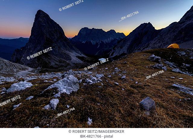 Peak of Sonnenspitze with tent and Zugspitze in the background at blue hour, Ehrwald, Außerfern, Tyrol, Austria