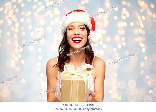 woman in santa hat with christmas gift