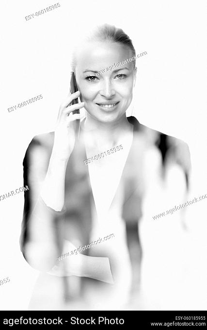 Beautiful young caucasian woman in business attire talking on smart phone on white background. Double exposure with abstract blur of business people overlay