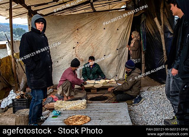 21 January 2020, Greece, Lesbos: Migrants prepare bread in a temporary camp next to the camp in Moria. The camps on the islands of Lesbos, Samos, Chios