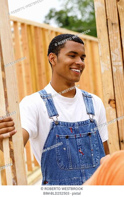 Mixed race man smiling at construction site