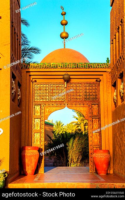 M'hamid, Morocco - February 22, 2016: typical arabic style front door outside view of Chez le Pacha hotel outside view with blue sky