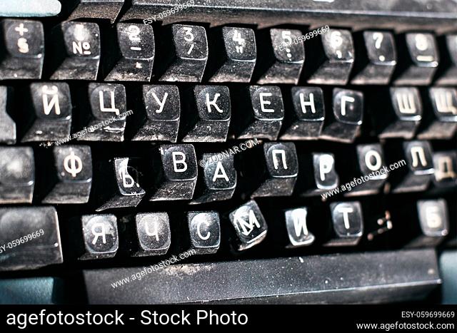 Outdated typewriter close-up. Broken keyboard with Russian letters. Background
