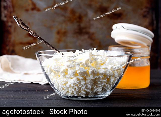 Natural homemade cottage cheese on dark table