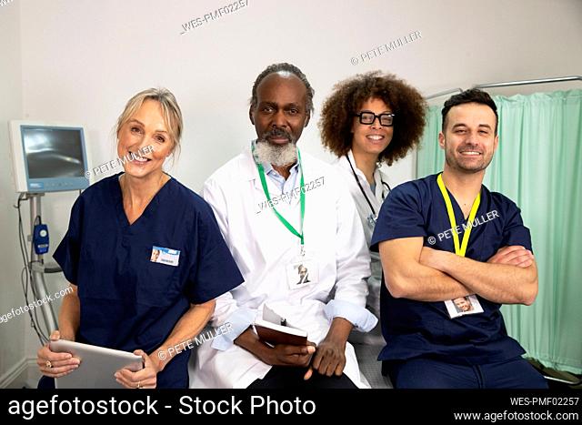 Smiling confident multiracial healthcare workers in medical room