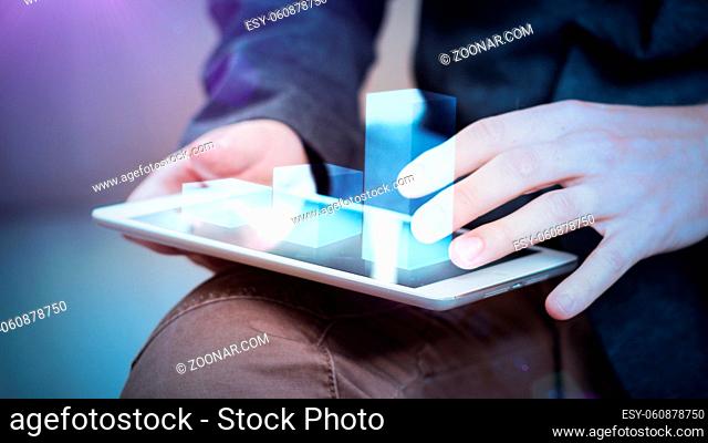 businessman interacts with hologram chart on a tablet, concept
