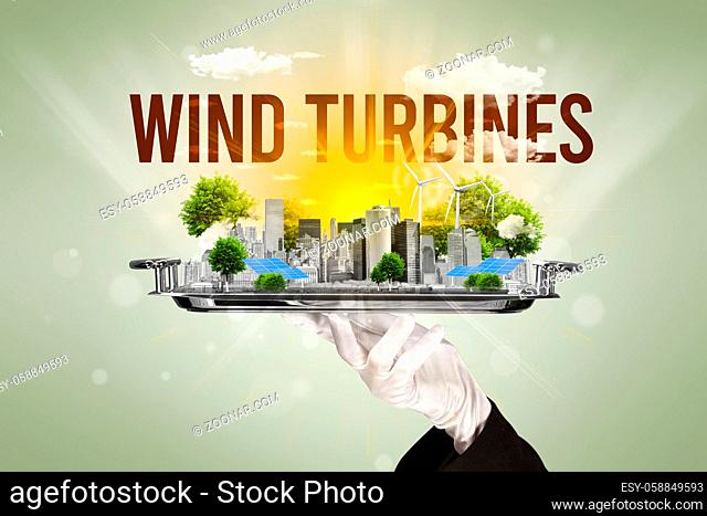 Waiter serving eco city with WIND TURBINES inscription, renewabke energy concept