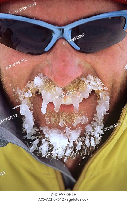 Skier with icy beard, Selkirk Mountains, British Columbia, Canada