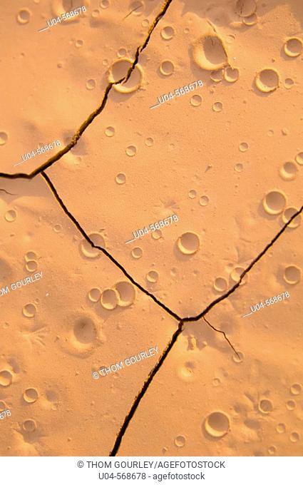 Raindrop craters in baked desert soil near Moab, Utah, USA
