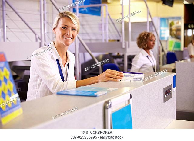 Portrait Of Staff At Airport Check In Desk
