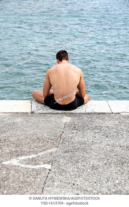 man resting at Paquis Plage, Geneva Lake, Geneva, Switzerland
