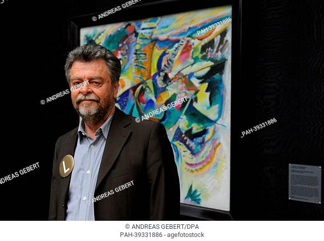 Museum director Helmut Friedel poses in front of Kandinsky's painting 'Improvisation Klamm' during the re-opening of Lenbachhaus in Munich,  Germany