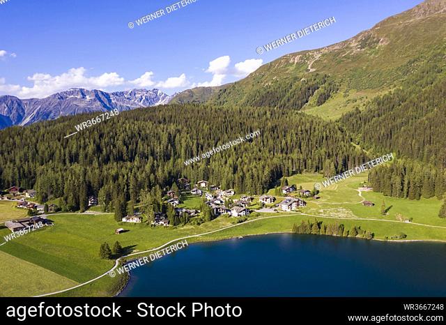 Switzerland, Canton of Grisons, Davos, Aerial view of villas on shore of Lake Davos in summer
