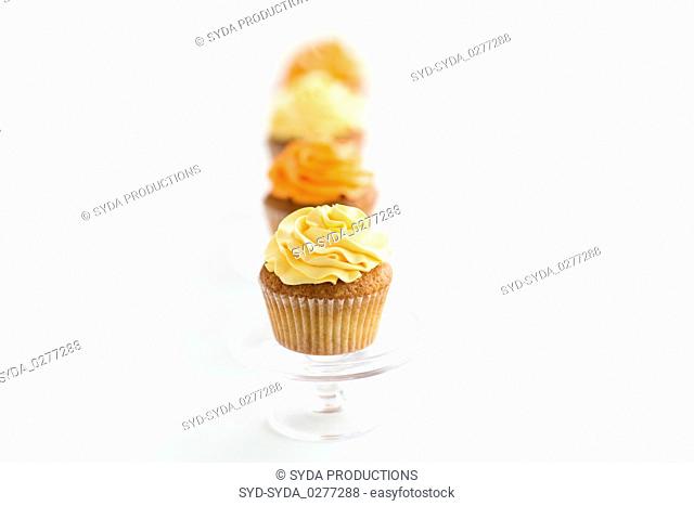 cupcakes with frosting on confectionery stands