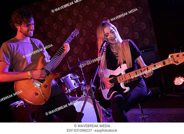 Male and female guitarist performing in nightclub