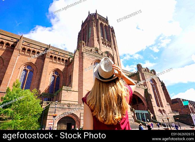 Tourism in Liverpool, UK. Back view of traveler girl visiting the Cathedral Church of Christ in Liverpool, England