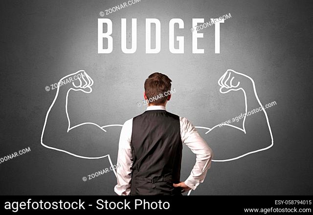 Rear view of a businessman with BUDGET inscription, powerfull business concept