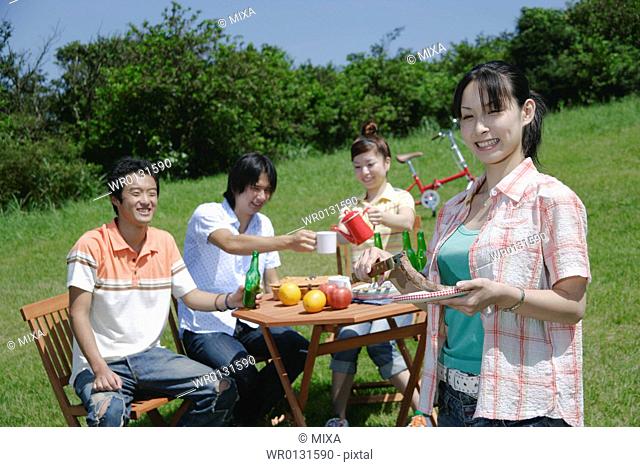 Four young people enjoying picnic
