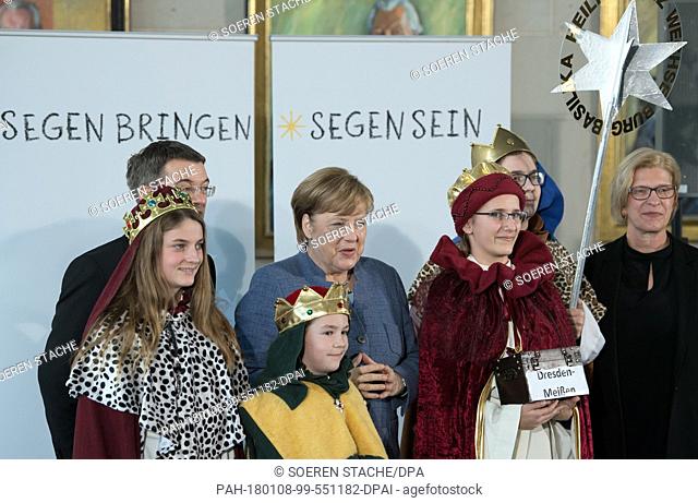 German chancellor Angela Merkel of the Christian Democratic Union »and prelate Klaus Kraemer, the president of the Association of Holy Youth (2L) greet the...