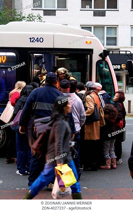 NEW YORK, NY, USA - OCTOBER 31, 2012: Bus Service having resumed after Hurricane Sandy hit the city, MTA busses remain rare and overcrowded in blacked-out Lower...