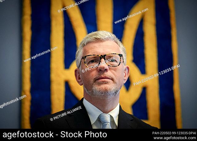 27 April 2022, Berlin: Andrij Melnyk, Ukraine's ambassador to Germany, looks into the photographer's camera in front of Ukraine's coat of arms in the embassy...