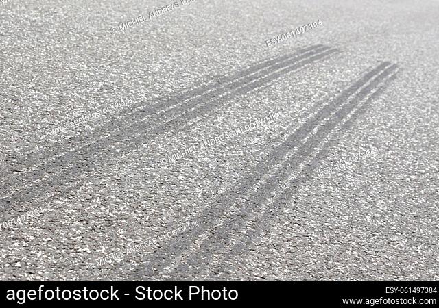 Auto tire rubber on the asphalt, selective focus