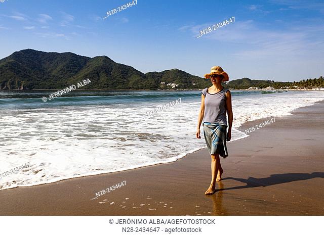 Woman walking on the beach, Pacific Ocean, Manzanillo, Colima, Mexico