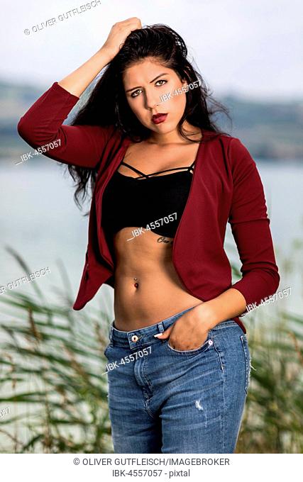 Portrait of a young woman with a wine red jacket and blue jeans