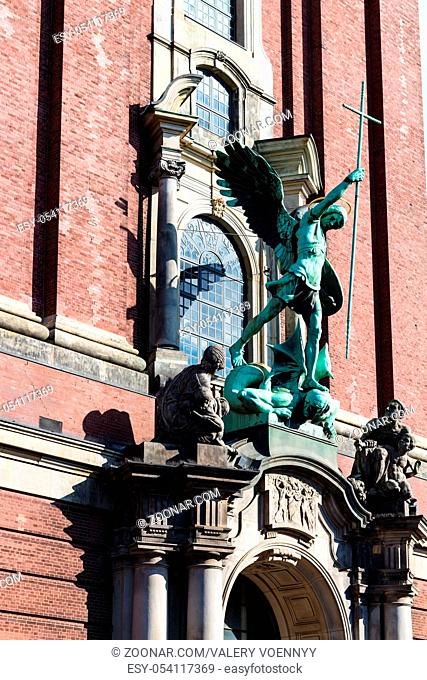 Travel to Germany - Victory of St Michael over the Devil, sculpture above the entrance of St Michael's church (Hauptkirche Sankt Michaelis) in Hamburg city