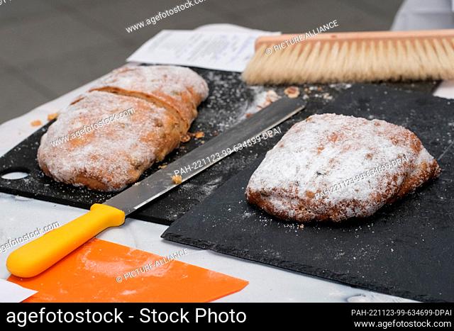 23 November 2022, Saxony-Anhalt, Halle: Stollen are cut and ready for testing. More than 20 bakers of the regional guild association from the south of...