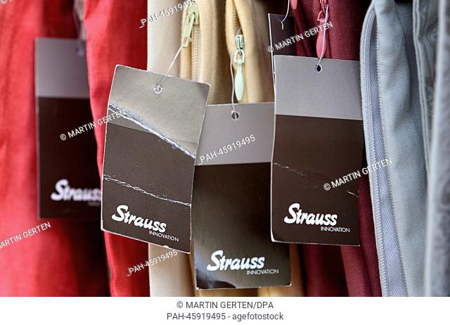 The Strauss Innovation logo stands on tags in a store in Duesseldorf, Germany, 30 January 2013. The troubled fashion chain wants to remove financial...