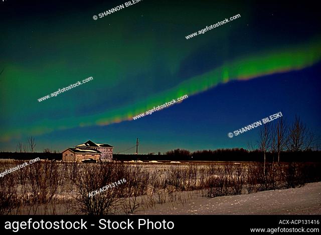 Aurora in the distance with rural Manitoba home