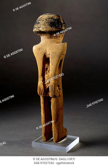 Ritual figurine, seen from behind with hands tied in a state of helplessness, painted wooden statue. Egyptian Civilisation, Middle Kingdom