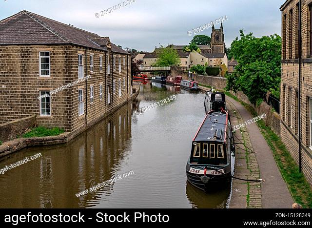 Skipton, North Yorkshire, England, UK - June 04, 2018: Houses and narrowboats on the shore of the Leeds and Liverpool Canal