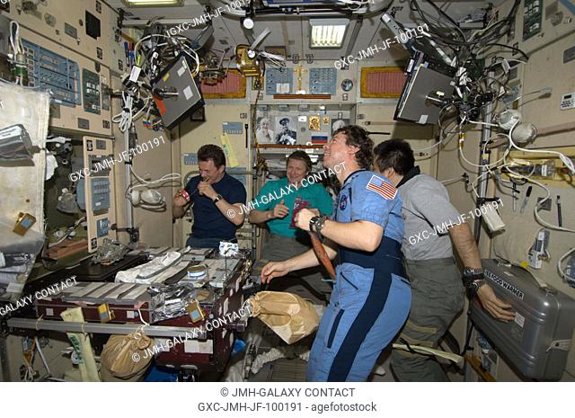 Expedition 20 crew members share a meal at the galley in the Zvezda Service Module of the International Space Station. Pictured (from the left) are cosmonauts...