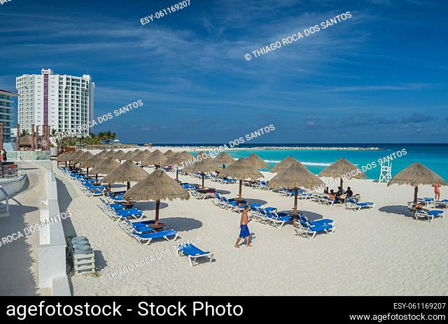 Cancun, Mexico - June 12, 2013: Straw sun umbrella on cancun beach, vacation rest, blue caribbean sea