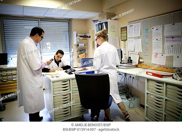 Reportage in the orthopedic service of robert bellanger hospital in france. a doctor with two junior doctors