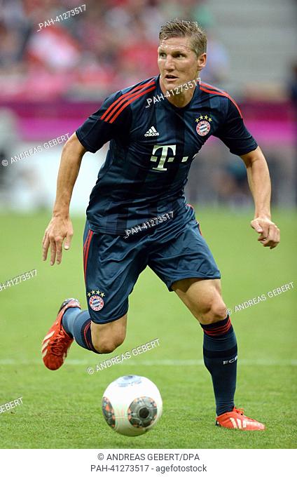 Munich's Bastian Schweinsteiger plays the ball during the test match Uli Hoeness Cup FC Bayern Munich vs FC Barcelona at the Allianz Arena in Munich, Germany