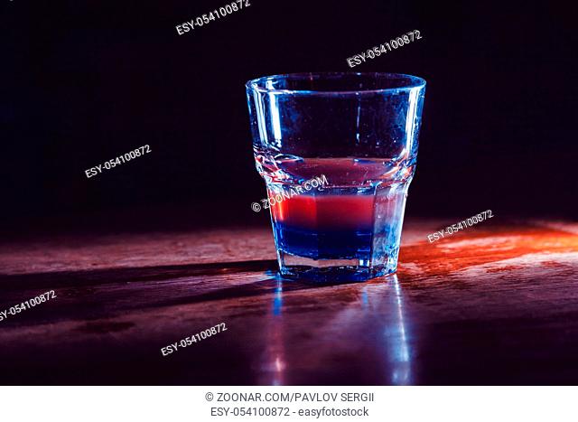 exotic cocktail with red and blue layers. close-up
