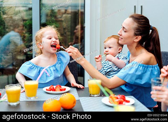 Happy family, fresh fruit breakfast in kitchen