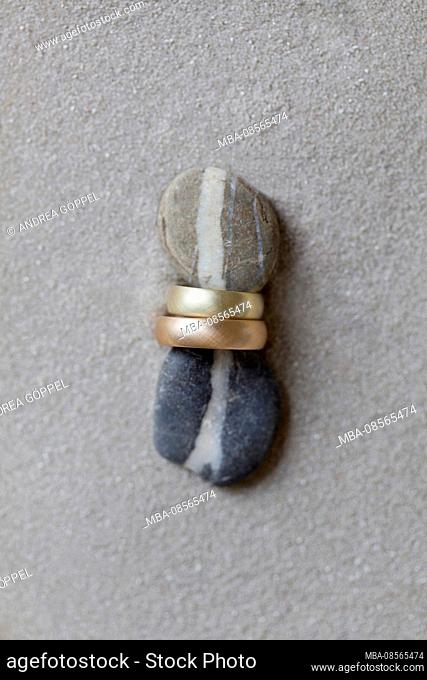 Wedding rings between two stones with continuous line of stones