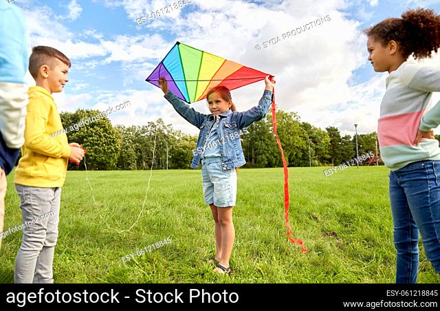 happy kids with kite playing at park